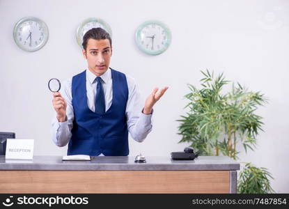 The young man receptionist at the hotel counter. Young man receptionist at the hotel counter