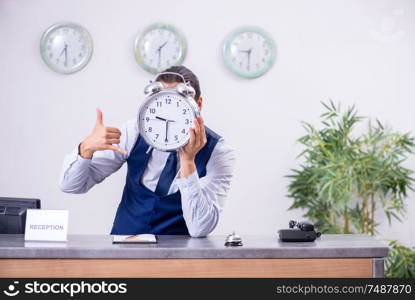 The young man receptionist at the hotel counter. Young man receptionist at the hotel counter