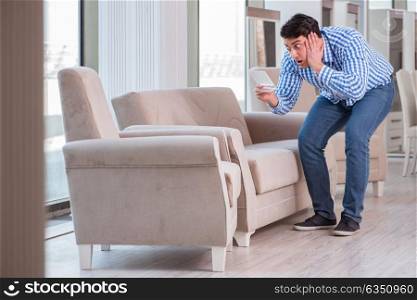 The young man shopping in furniture store. Young man shopping in furniture store