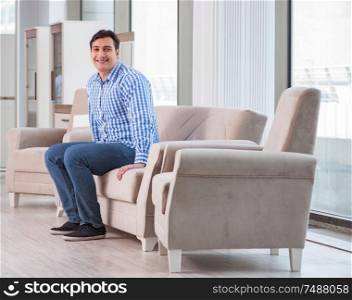 The young man shopping in furniture store. Young man shopping in furniture store