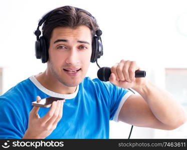 The young man singing at home karaoke. Young man singing at home karaoke