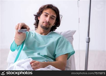 The young man staying in hospital in transfusion concept. Young man staying in hospital in transfusion concept