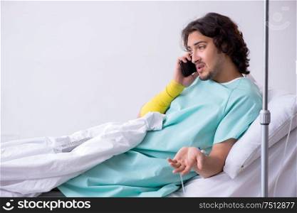 The young man staying in hospital in transfusion concept. Young man staying in hospital in transfusion concept