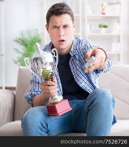 The young man student watching football at home. Young man student watching football at home