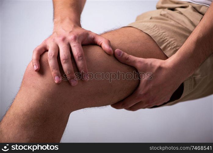The young man suffering from leg pain . Young man suffering from leg pain