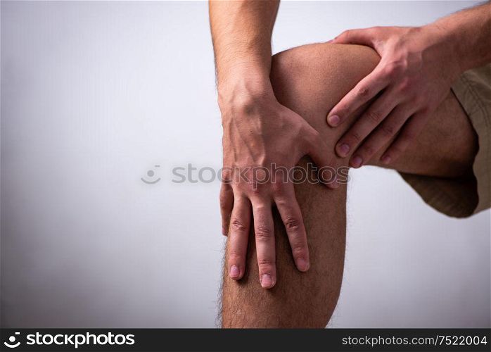 The young man suffering from leg pain. Young man suffering from leg pain