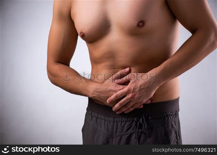 The young man suffering from stomachache. Young man suffering from stomachache