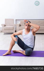 The young man training and exercising at home. Young man training and exercising at home