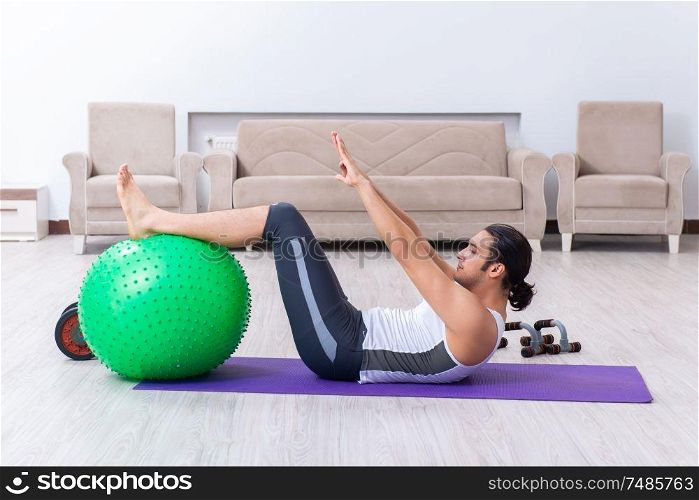 The young man training and exercising at home. Young man training and exercising at home
