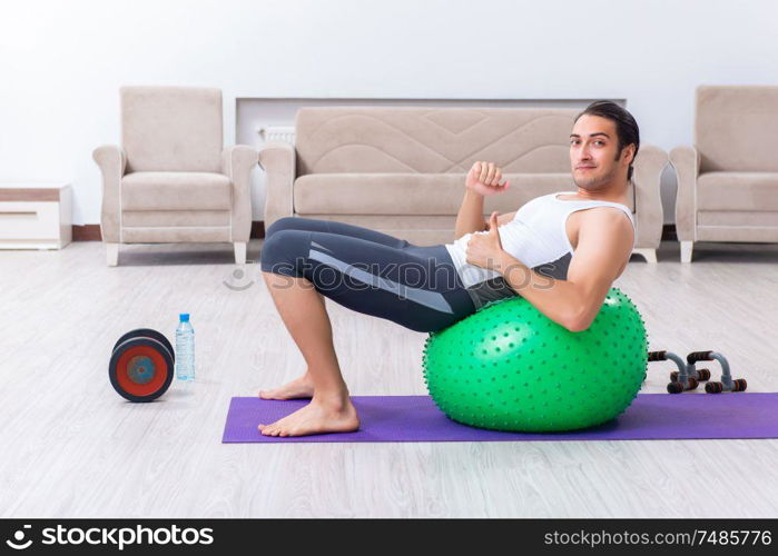 The young man training and exercising at home. Young man training and exercising at home