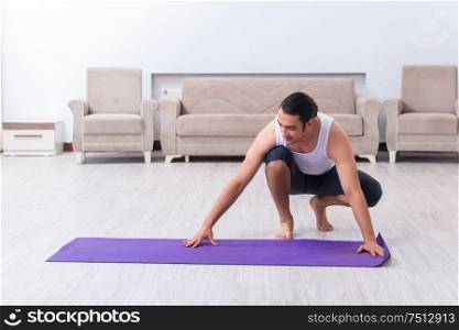 The young man training and exercising at home. Young man training and exercising at home