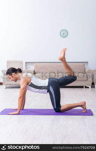 The young man training and exercising at home. Young man training and exercising at home