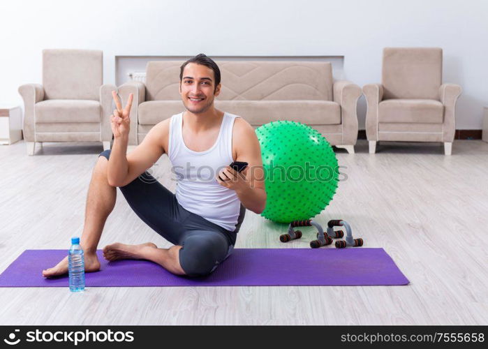 The young man training and exercising at home. Young man training and exercising at home