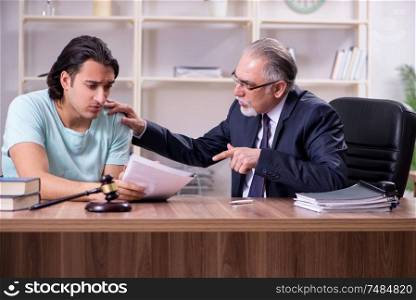 The young man visiting experienced male lawyer . Young man visiting experienced male lawyer