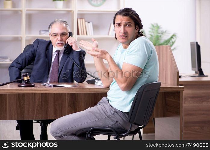 The young man visiting experienced male lawyer. Young man visiting experienced male lawyer