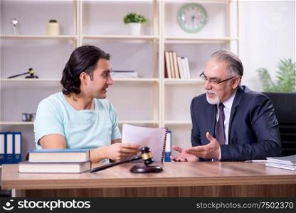 The young man visiting experienced male lawyer. Young man visiting experienced male lawyer