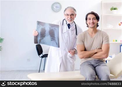 The young man visiting old male doctor radiologist. Young man visiting old male doctor radiologist