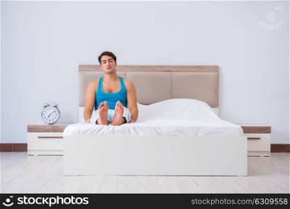The young man waking up in bed. Young man waking up in bed