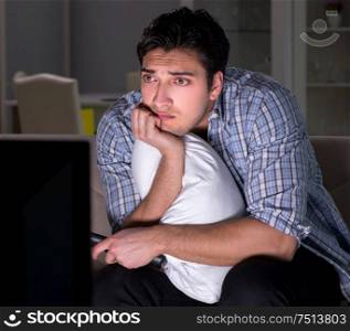 The young man watching tv late at night. Young man watching tv late at night