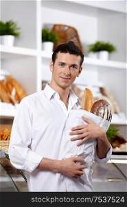 The young man with a package in a baker?s shop