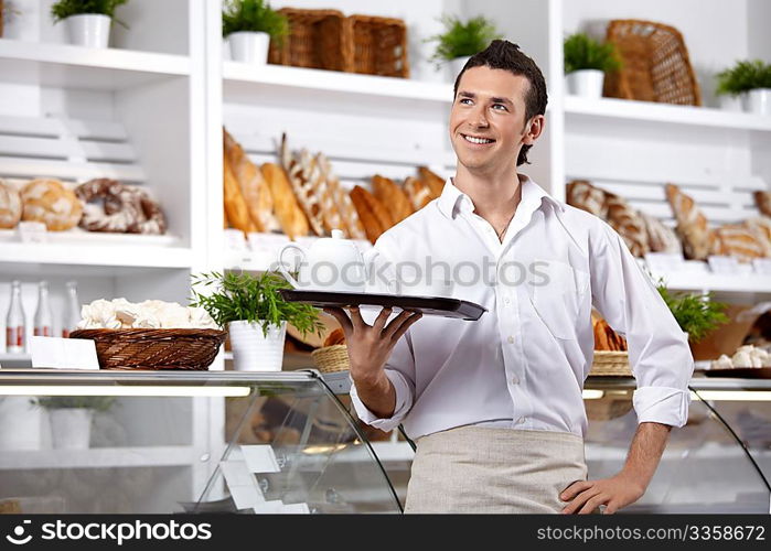 The young man with a tray on a forward background