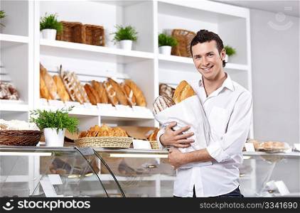 The young man with bread in shop