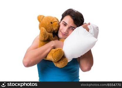 The young man with pillow isolated on white background. Young man with pillow isolated on white background