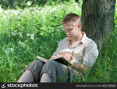 The young man with the book in park