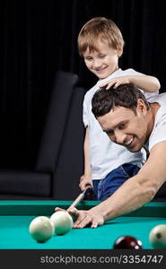 The young man with the son plays billiards