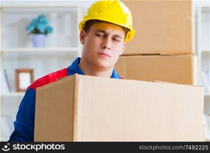 The young man working in relocation services with boxes. Young man working in relocation services with boxes