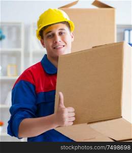 The young man working in relocation services with boxes. Young man working in relocation services with boxes