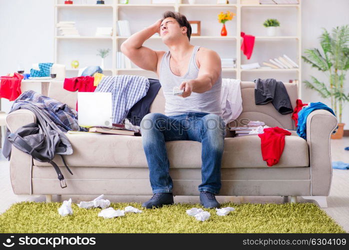 The young man working studying in messy room. Young man working studying in messy room