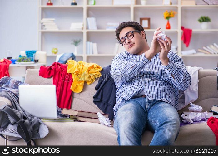 The young man working studying in messy room. Young man working studying in messy room