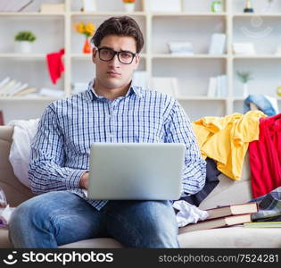 The young man working studying in messy room. Young man working studying in messy room