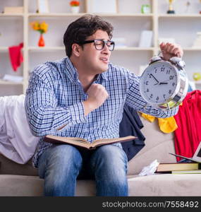 The young man working studying in messy room. Young man working studying in messy room