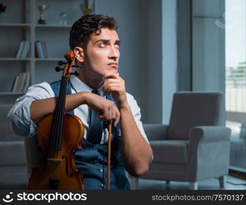 The young musician man practicing playing violin at home. Young musician man practicing playing violin at home