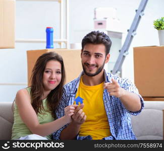 The young pair moving in to new apartment under mortgage. Young pair moving in to new apartment under mortgage