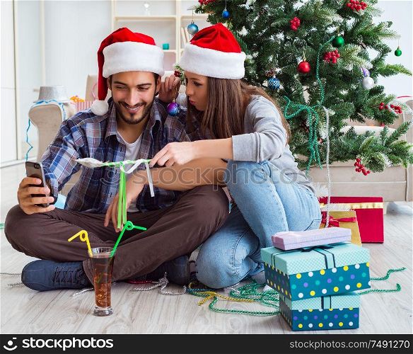 The young pair taking selfies during christmas. Young pair taking selfies during christmas
