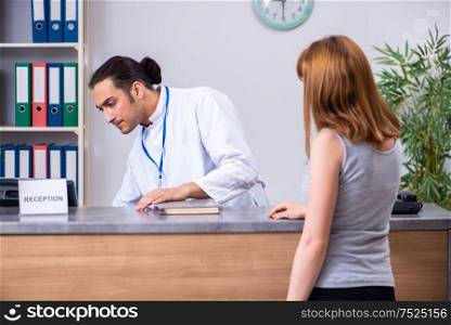 The young patient at the reception in the hospital. Young patient at the reception in the hospital