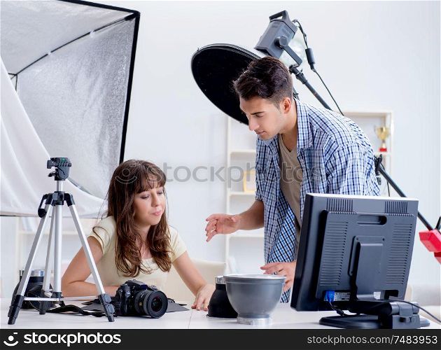The young photographer working in photo studio. Young photographer working in photo studio