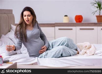 The young pregnant woman in the bedroom. Young pregnant woman in the bedroom