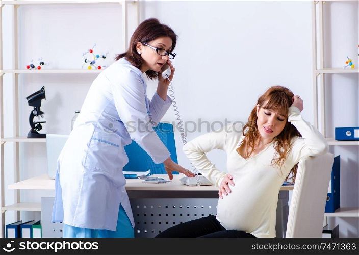 The young pregnant woman visiting experienced doctor gynecologist. Young pregnant woman visiting experienced doctor gynecologist