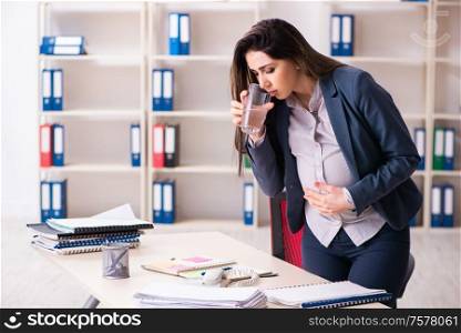 The young pregnant woman working in the office. Young pregnant woman working in the office