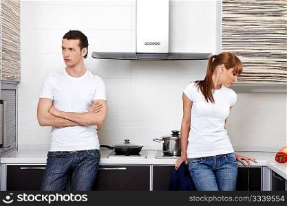 The young quarrelled couple on kitchen