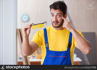 The young repairman carpenter working cutting wood. Young repairman carpenter working cutting wood