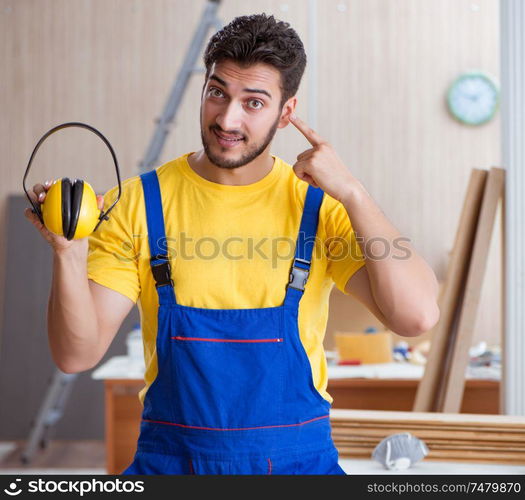 The young repairman carpenter working cutting wood. Young repairman carpenter working cutting wood