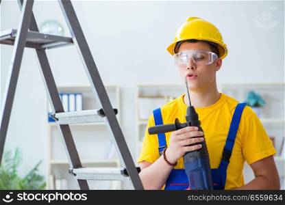 The young repairman with power drill. Young repairman with power drill