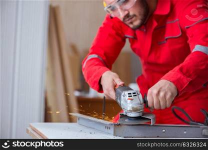 The young repairman working with a grinding wheel. Young repairman working with a grinding wheel