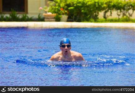 The young sports swimmer in pool