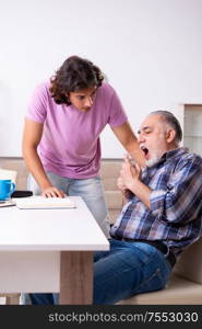 The young student and his old grandpa at home. Young student and his old grandpa at home